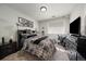 Modern bedroom featuring a cozy bed with plush bedding, desk, dresser, and neutral color palette at 4474 Copeland Cir # 102, Highlands Ranch, CO 80126