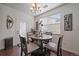 Cozy dining area features modern chandelier, round table, and stylish decor near a door and window at 4474 Copeland Cir # 102, Highlands Ranch, CO 80126