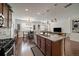 Open kitchen with granite countertops, hardwood floors, stainless appliances, and dining area at 4474 Copeland Cir # 102, Highlands Ranch, CO 80126