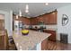 Contemporary kitchen showcasing a center island with granite countertop and modern appliances at 4474 Copeland Cir # 102, Highlands Ranch, CO 80126