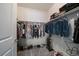 Organized walk-in closet with clothing racks, shelves, shoes, and neutral carpeting providing ample storage at 4474 Copeland Cir # 102, Highlands Ranch, CO 80126
