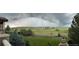 Expansive backyard with lush lawn and mature trees, offering privacy and scenic views at 5603 Twilight Way, Parker, CO 80134