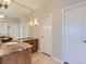 Bathroom vanity featuring a large mirror, granite countertops and custom wood cabinetry at 5603 Twilight Way, Parker, CO 80134