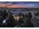 Beautiful home at dusk with elegant design and landscaping, set against a scenic neighborhood backdrop at 5603 Twilight Way, Parker, CO 80134