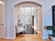 Elegant foyer with arched entry, chandelier, black marble floor, and light wood floors at 5603 Twilight Way, Parker, CO 80134