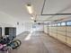 Clean, organized three-car garage featuring ample storage space, overhead lighting, and bicycle parking at 5603 Twilight Way, Parker, CO 80134