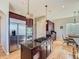 Gourmet kitchen with stainless steel appliances, a gas cooktop island, and rich burgundy cabinets, ready for cooking at 5603 Twilight Way, Parker, CO 80134