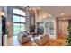 Bright living room with fireplace, built-in shelves, hardwood floors, and large windows at 5603 Twilight Way, Parker, CO 80134