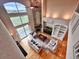 Aerial view of a bright living room with fireplace, built-in shelves, hardwood floors and large windows at 5603 Twilight Way, Parker, CO 80134