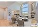 Bright living room with hardwood floors, large windows, and a cozy fireplace, seamlessly connected to the kitchen at 5603 Twilight Way, Parker, CO 80134