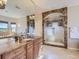 Elegant bathroom features double sinks, a luxurious shower, and granite counters for a spa-like experience at 5603 Twilight Way, Parker, CO 80134