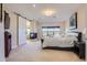 Bright main bedroom with a fireplace, sitting area, barn door, and large windows with neighborhood views at 5603 Twilight Way, Parker, CO 80134
