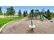Community playground with green slide, climbing structure, and mature trees near a sports field at 5603 Twilight Way, Parker, CO 80134
