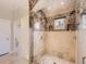 Stunning shower stall with intricate tile work, multiple shower heads, a glass door, and built-in shelves at 5603 Twilight Way, Parker, CO 80134