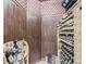 Custom wine cellar with wood paneling and shelving, designed for storing and showcasing an extensive wine collection at 5603 Twilight Way, Parker, CO 80134