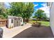 Backyard featuring a shed, patio area with a picnic table, and lush green grass for outdoor enjoyment at 17177 E Milan Cir, Aurora, CO 80013