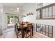 Dining area with wood table, sliding door leading to the backyard, and stylish decor at 17177 E Milan Cir, Aurora, CO 80013