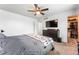 Bedroom featuring a ceiling fan, dark dresser, and access to a walk-in closet, providing ample storage space at 17177 E Milan Cir, Aurora, CO 80013