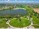 Expansive aerial view of a lake surrounded by lush greenery, walking paths, and residential areas at 805 Summer Hawk Dr # 100, Longmont, CO 80504