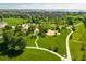 Breathtaking aerial view of a vibrant park with walking trails near a tranquil lake and neighborhood at 805 Summer Hawk Dr # 100, Longmont, CO 80504