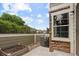 Secluded back patio with a garden bed, an AC unit, and stone accents at 805 Summer Hawk Dr # 100, Longmont, CO 80504