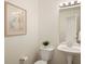Clean powder room with a pedestal sink, framed mirror, and decorative wall art at 805 Summer Hawk Dr # 100, Longmont, CO 80504