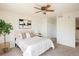 Well-lit bedroom features neutral decor, modern ceiling fan, and closet at 805 Summer Hawk Dr # 100, Longmont, CO 80504