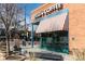 Ziggi's Coffee red brick shop front with red and white awning and outdoor seating on a pedestrian friendly street at 805 Summer Hawk Dr # 100, Longmont, CO 80504