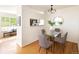 Bright dining area with a glass top table, seating for four, and modern lighting at 805 Summer Hawk Dr # 100, Longmont, CO 80504
