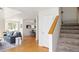 Inviting entryway with stairs, hardwood floors, and a view to the living room at 805 Summer Hawk Dr # 100, Longmont, CO 80504