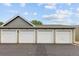 View of detached garages with light green doors and gray roof at 805 Summer Hawk Dr # 100, Longmont, CO 80504
