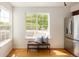 Sunlit kitchen nook with a large window, bench seating, and stainless steel refrigerator at 805 Summer Hawk Dr # 100, Longmont, CO 80504