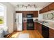 Well-equipped kitchen with stainless steel appliances and dark wood cabinetry at 805 Summer Hawk Dr # 100, Longmont, CO 80504