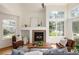 Inviting living room featuring a fireplace, hardwood floors, and large windows for ample natural light at 805 Summer Hawk Dr # 100, Longmont, CO 80504