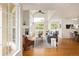 Bright living room featuring high ceilings, many windows, a fireplace, and hardwood floors at 805 Summer Hawk Dr # 100, Longmont, CO 80504