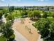 Aerial view of a colorful community playground featuring various play structures and green space at 805 Summer Hawk Dr # 100, Longmont, CO 80504