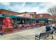 Brick building for Pumphouse Brewery and Restaurant features outdoor dining with wrought iron furniture under a covered patio at 805 Summer Hawk Dr # 100, Longmont, CO 80504