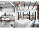 Bright bedroom boasts a modern ceiling fan, white bedding and a large window with fantastic city views at 100 Park W Ave # 2008, Denver, CO 80205