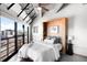 Bright bedroom with floor-to-ceiling windows showcasing city views and modern design elements at 100 Park W Ave # 2008, Denver, CO 80205