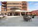 Exterior view of 100 Park Avenue West features an inviting entrance and outdoor seating area at 100 Park W Ave # 2008, Denver, CO 80205