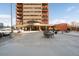 Exterior view of building with parking and outdoor seating at 100 Park W Ave # 2008, Denver, CO 80205