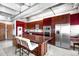 Modern kitchen boasts cherry cabinets, stainless appliances, an island and a cityscape view at 100 Park W Ave # 2008, Denver, CO 80205