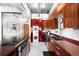 Modern kitchen features cherry cabinets, stainless appliances and convenient laundry at 100 Park W Ave # 2008, Denver, CO 80205