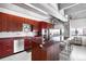 Modern kitchen features sleek red cabinets, stainless steel appliances, island and cityscape view at 100 Park W Ave # 2008, Denver, CO 80205