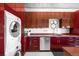 Well-equipped modern kitchen with cherry cabinets, stainless appliances, and laundry conveniently located within the space at 100 Park W Ave # 2008, Denver, CO 80205