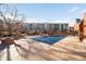 Pool with a partially covered blue tarp, patio, and building in background at 100 Park W Ave # 2008, Denver, CO 80205