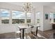 Bright dining area with large windows and a rustic wooden table at 13300 Monaco Ct, Thornton, CO 80602