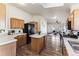 Open kitchen features an island and stainless steel appliances at 5768 Alcott St, Denver, CO 80221