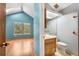 View into a bathroom, showing the vanity, toilet, and tile floor at 1209 S Flower Cir # C, Lakewood, CO 80232
