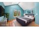 Comfortable bedroom with vaulted ceiling, skylight, hardwood floor, and natural light at 1209 S Flower Cir # C, Lakewood, CO 80232